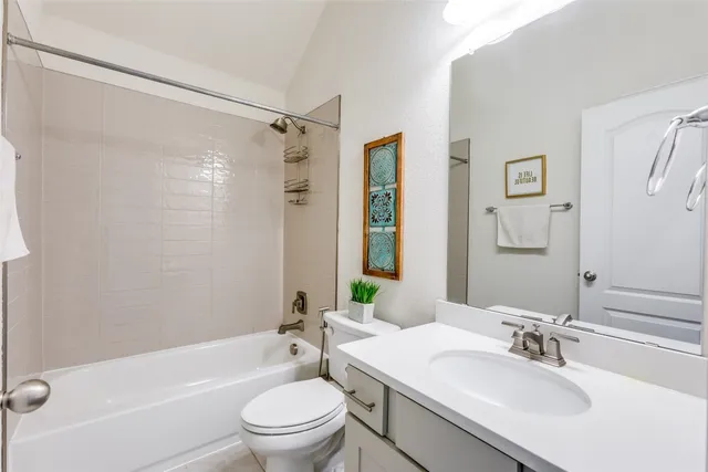 a bathroom with a sink toilet tub and shower
