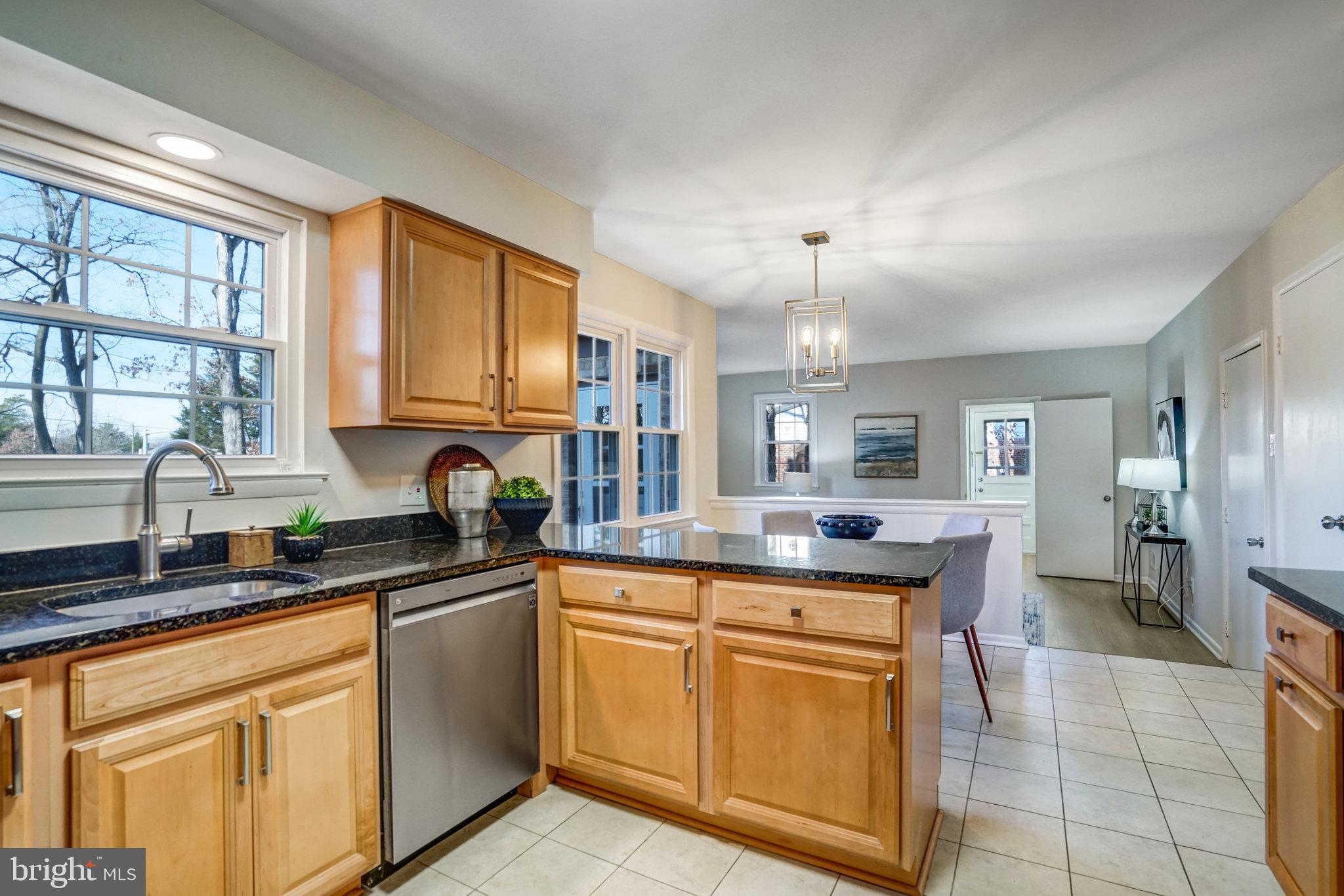 6002 Sherborn Lane Springfield, VA 22152 - Photo 14 of 52 a kitchen with stainless steel appliances granite countertop a sink and cabinets