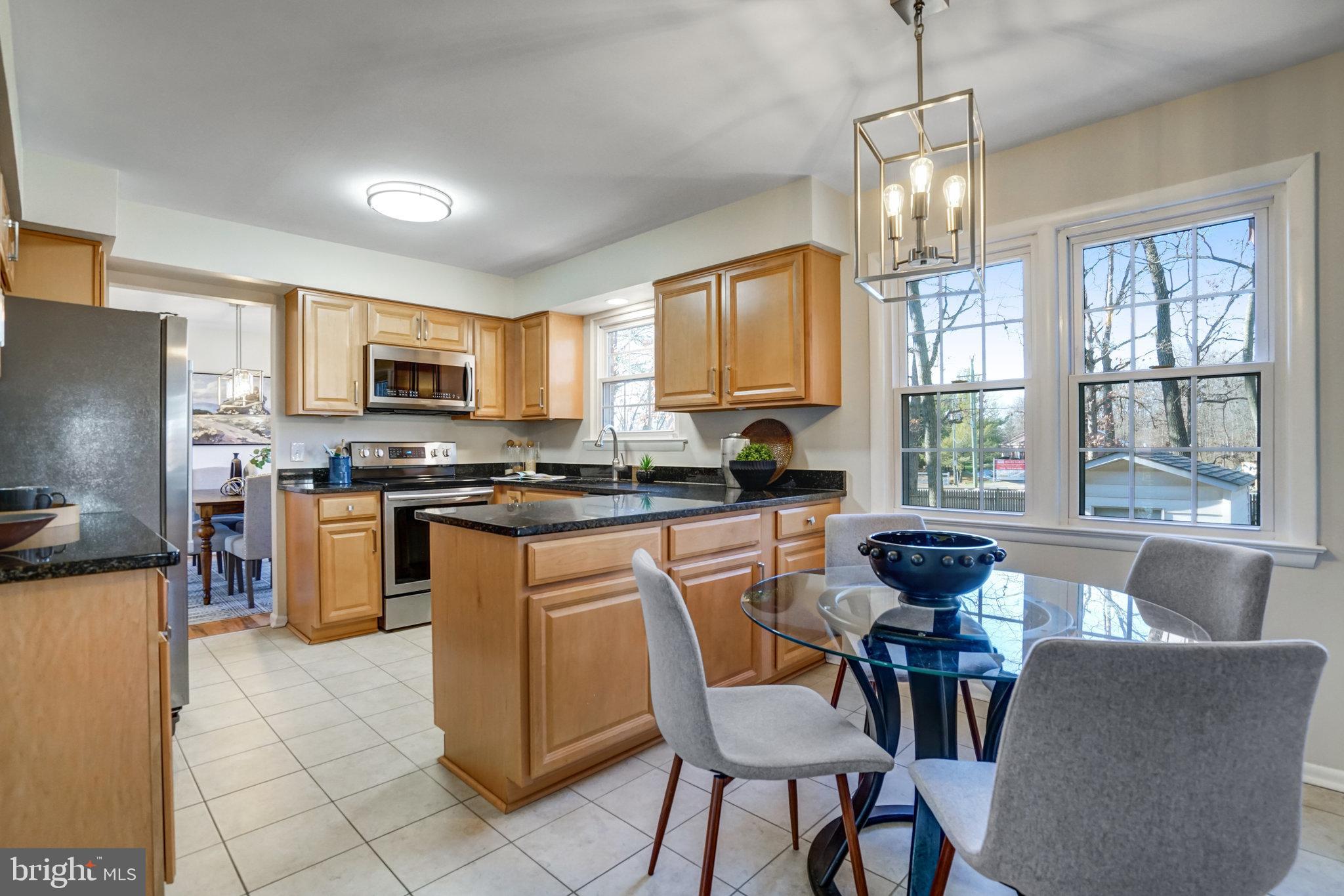 6002 Sherborn Lane Springfield, VA 22152 - Photo 19 of 52 a kitchen with microwave a stove and furniture