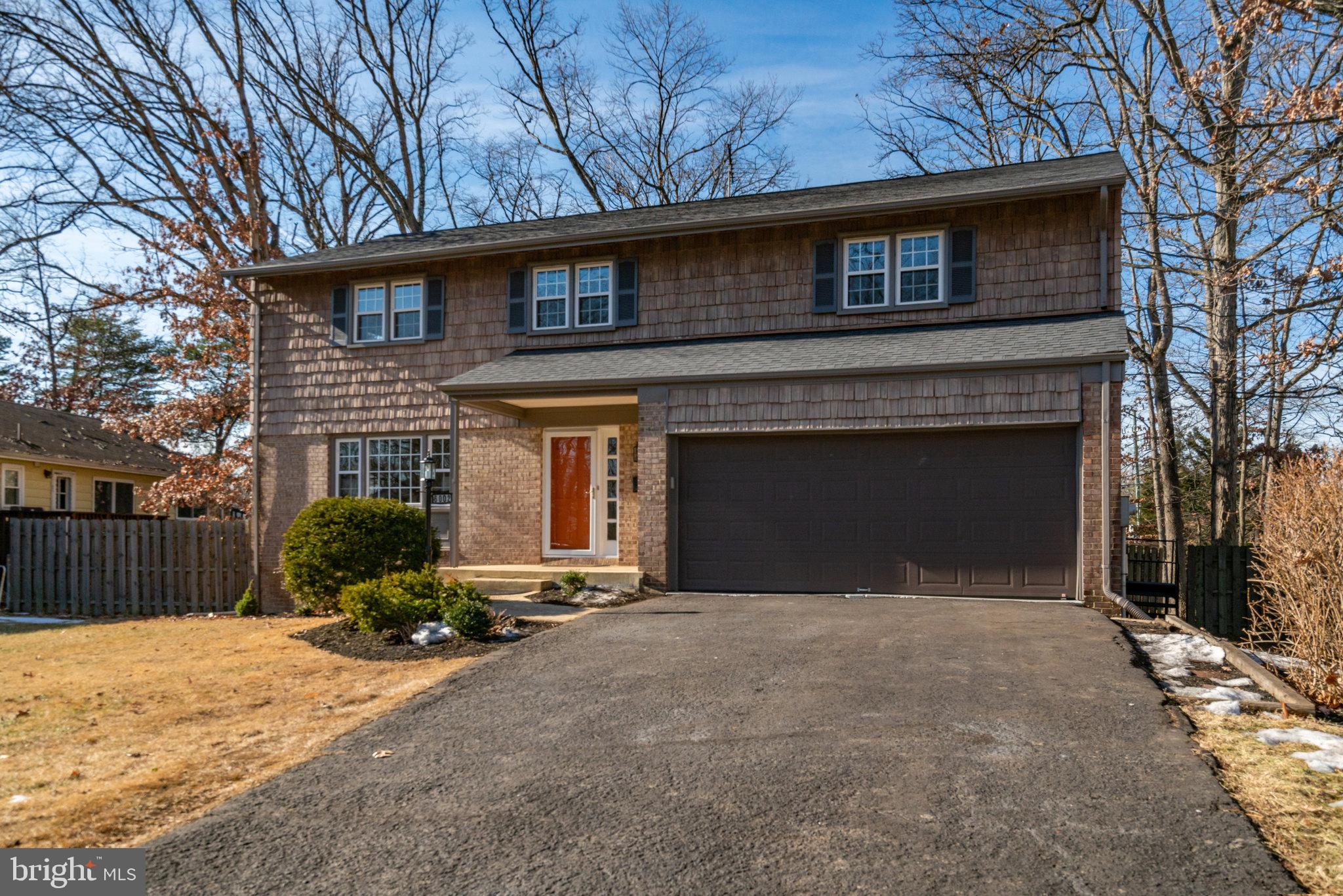 6002 Sherborn Lane Springfield, VA 22152 - Photo 2 of 52 a front view of a house with a yard and garage