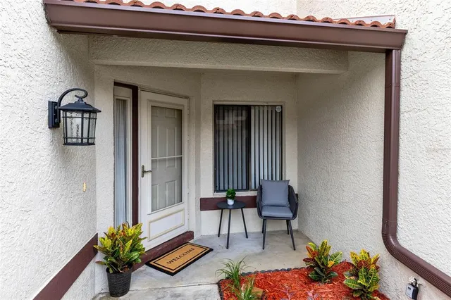 a balcony with furniture and a potted plant