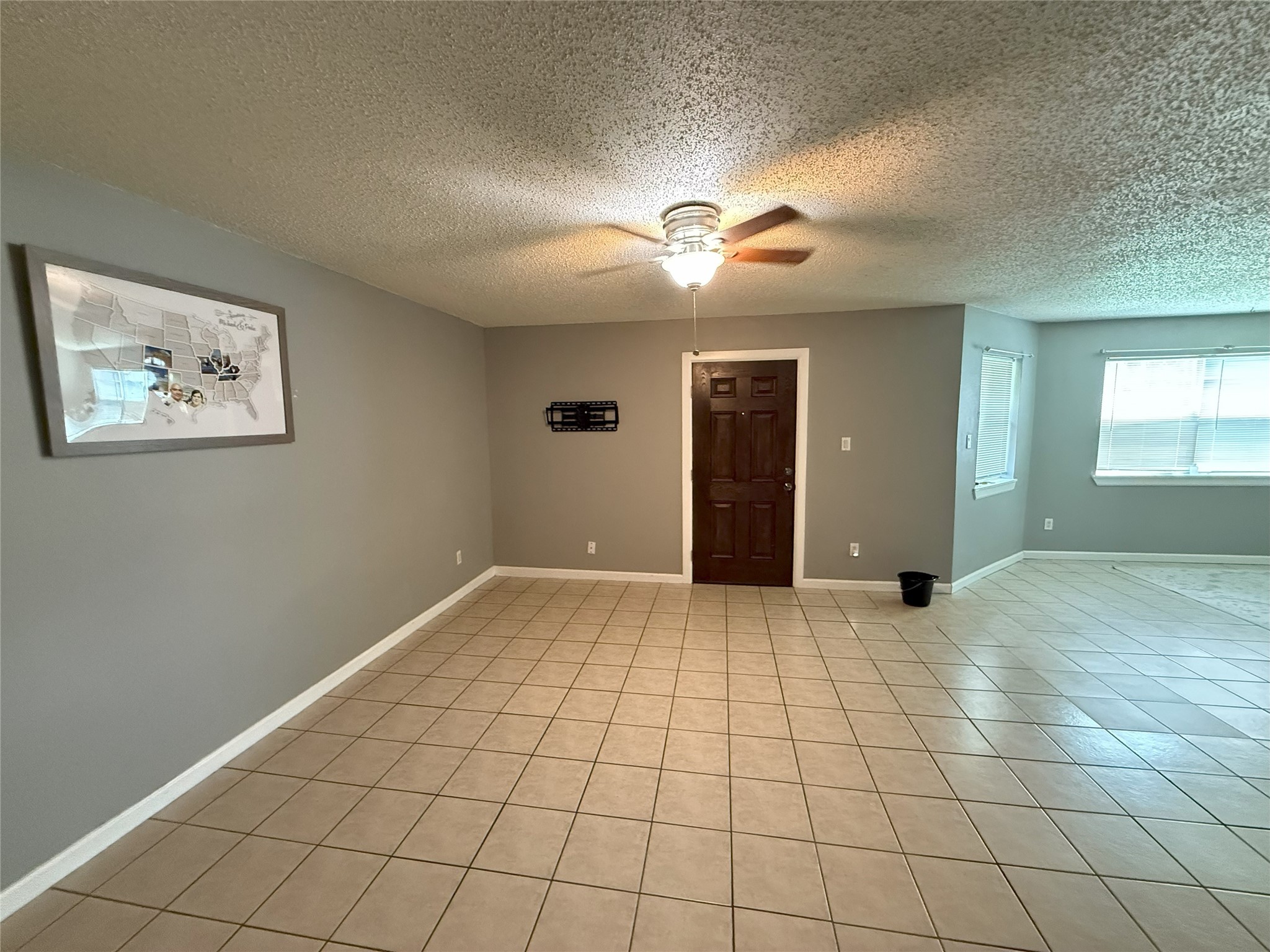 409 Bauer Drive Port Lavaca, TX 77979 - Photo 3 of 13 an empty room with windows and chandelier fan