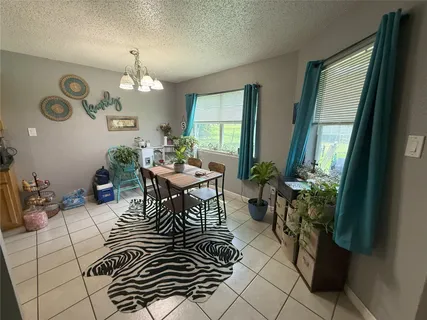 a living room with furniture a flat screen tv and a table