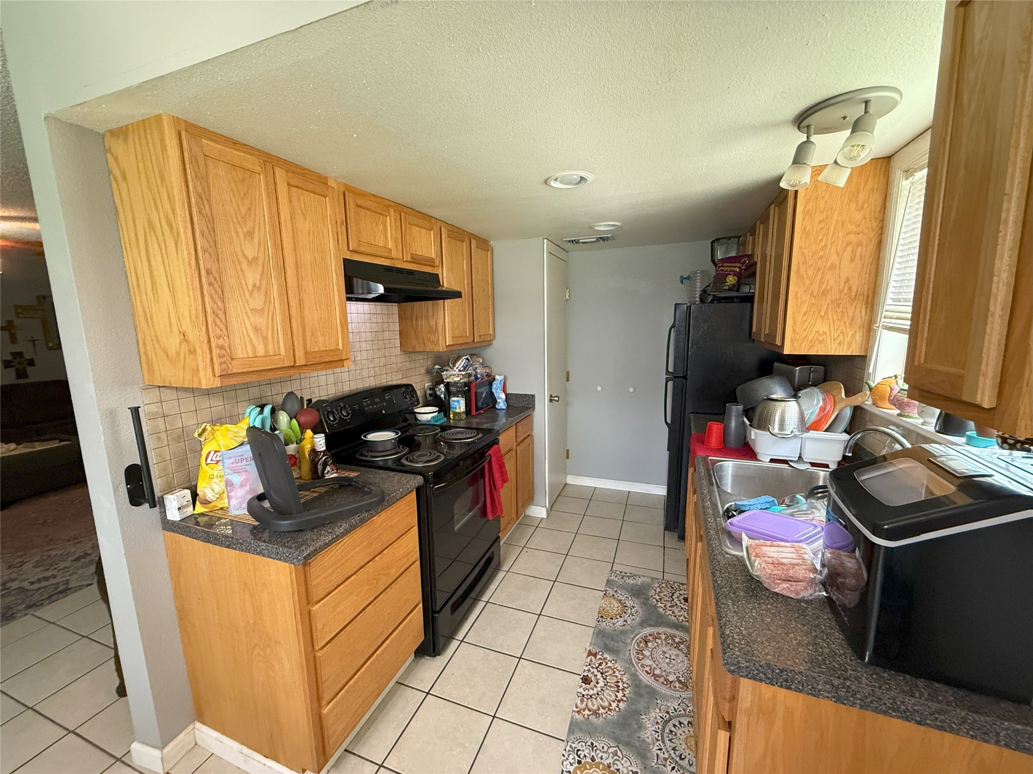 409 Bauer Drive Port Lavaca, TX 77979 - Photo 8 of 13 a kitchen with stainless steel appliances granite countertop sink stove and cabinets