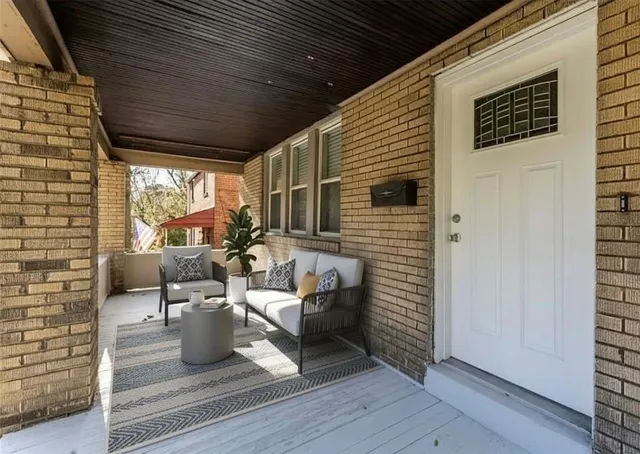 a view of a patio with table and chairs and wooden floor