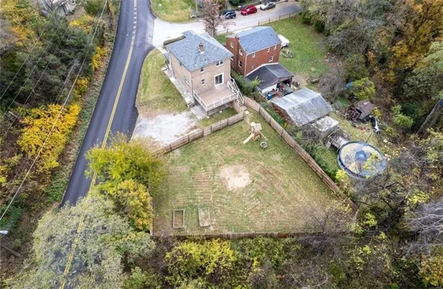 an aerial view of a house with yard swimming pool and outdoor seating