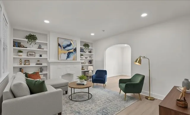a living room with furniture and a potted plant