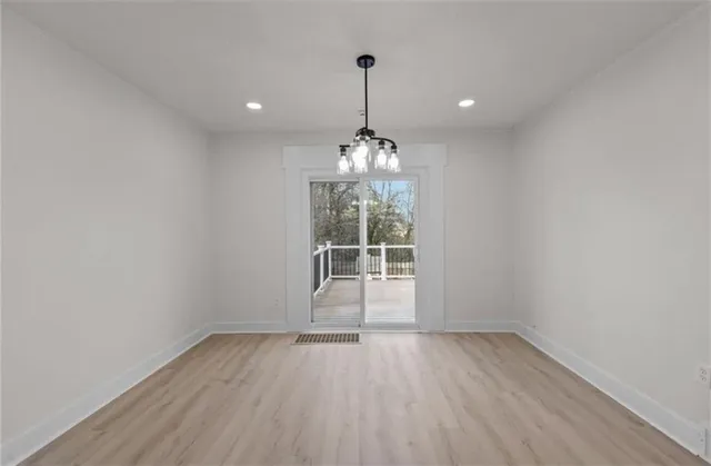 a view of a room with wooden floor and window