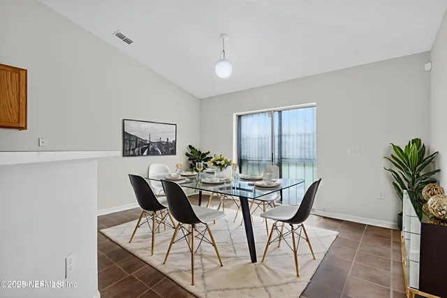 a dining room with furniture and window