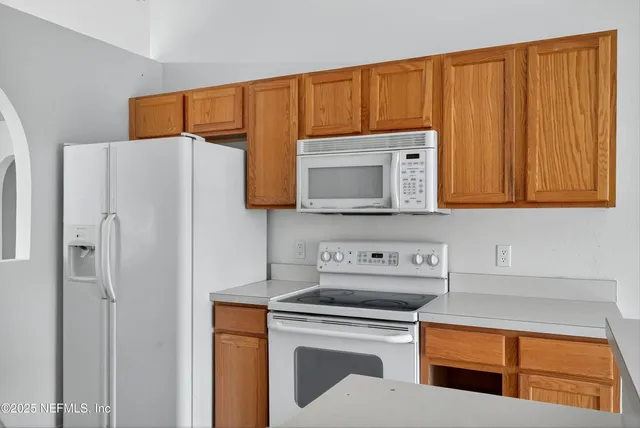 a kitchen with stainless steel appliances a stove a microwave and cabinets