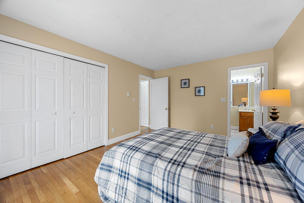 800 Bearses Way, Unit 1WD Hyannis, MA 02601 - Photo 11 of 24 a bedroom with a bed and wooden floor