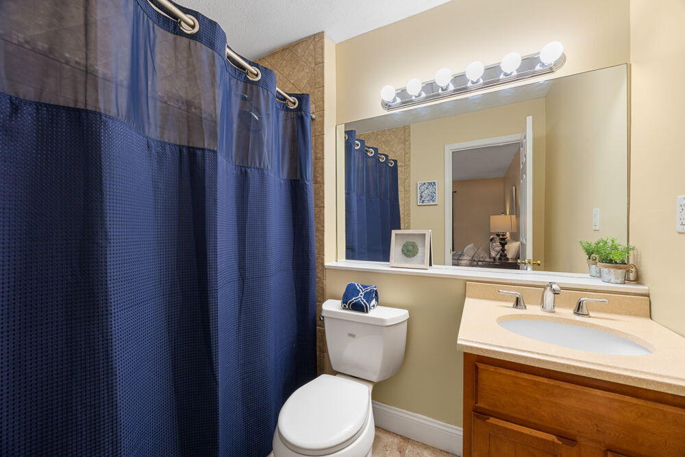 800 Bearses Way, Unit 1WD Hyannis, MA 02601 - Photo 13 of 24 a bathroom with a toilet a sink and mirror