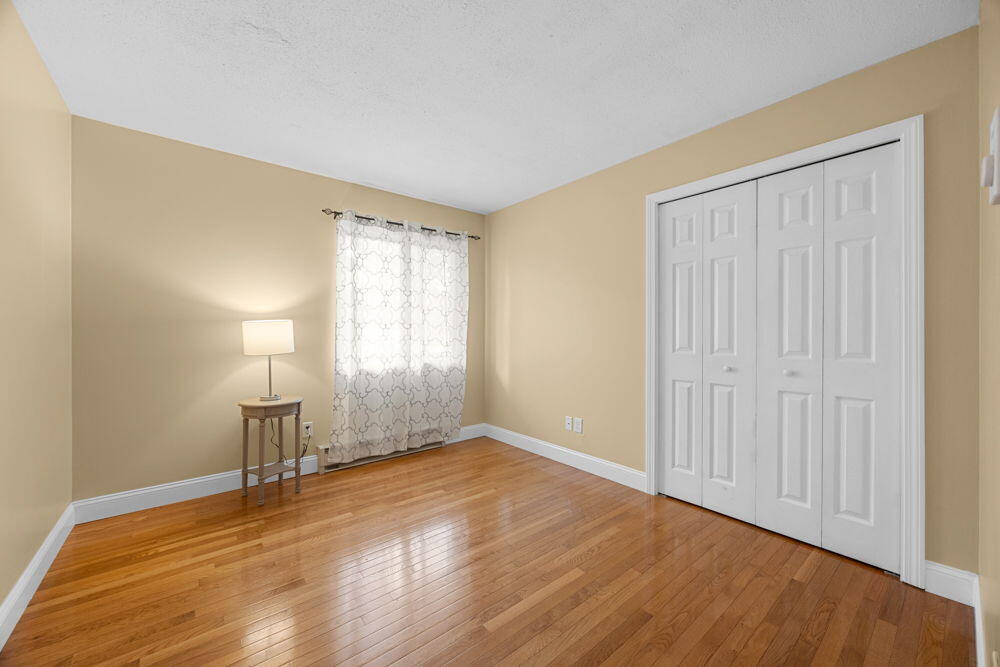 800 Bearses Way, Unit 1WD Hyannis, MA 02601 - Photo 14 of 24 a view of empty room with wooden floor and fan
