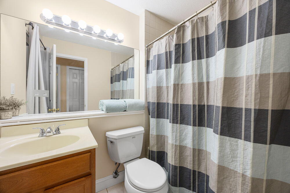 800 Bearses Way, Unit 1WD Hyannis, MA 02601 - Photo 16 of 24 a bathroom with a sink a toilet a mirror and shower