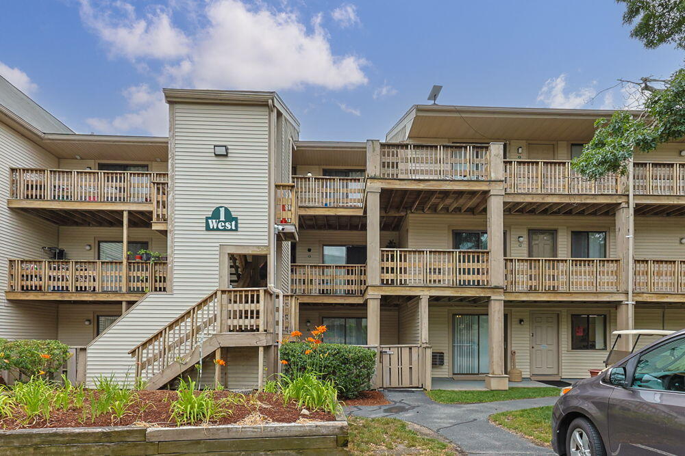 800 Bearses Way, Unit 1WD Hyannis, MA 02601 - Photo 24 of 24 a front view of a residential apartment building with a yard
