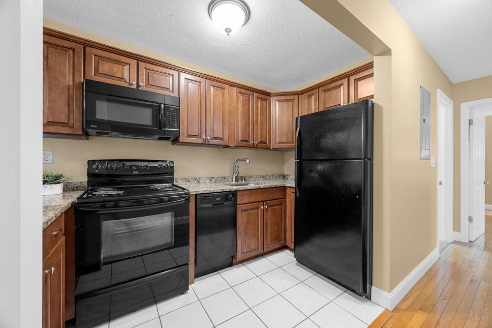 800 Bearses Way, Unit 1WD Hyannis, MA 02601 - Photo 7 of 24 a kitchen with a refrigerator stove and microwave