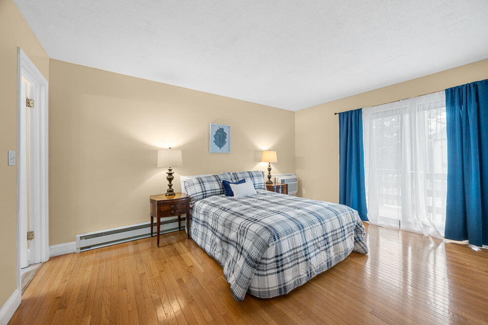 800 Bearses Way, Unit 1WD Hyannis, MA 02601 - Photo 10 of 24 a bedroom with a bed and wooden floor