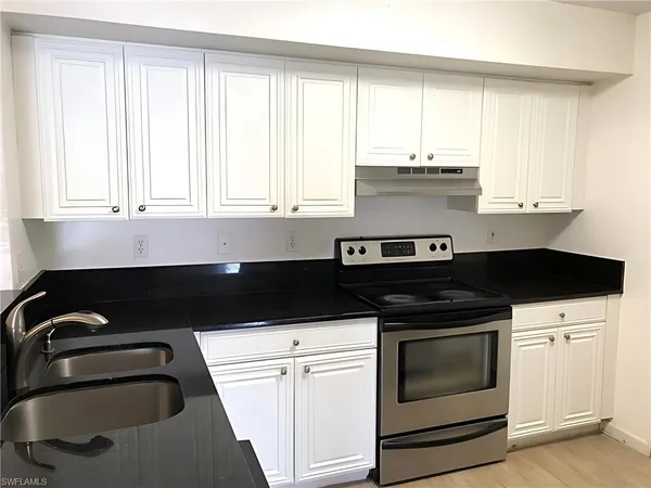 a kitchen with a stove and a sink