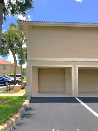 a front view of a house with a yard and a garage