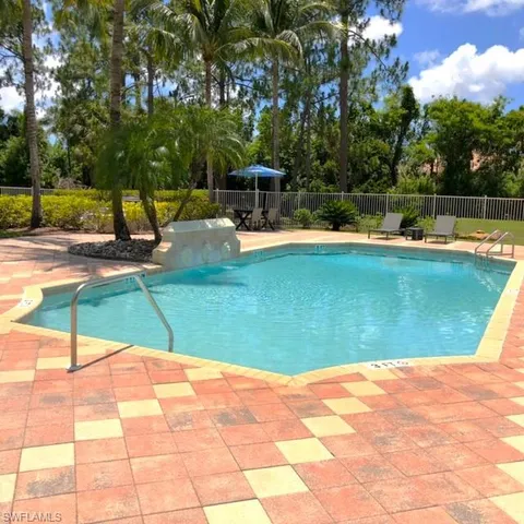 a view of a swimming pool with a yard