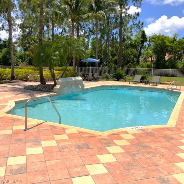 8255 Ibis Club Drive, Unit 508 Naples, FL 34104 - Photo 2 of 14 a view of a swimming pool with a yard