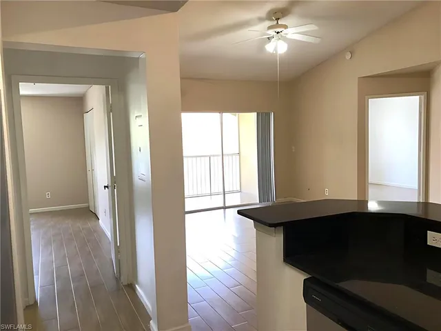 a view of a livingroom with wooden floor and a ceiling fan
