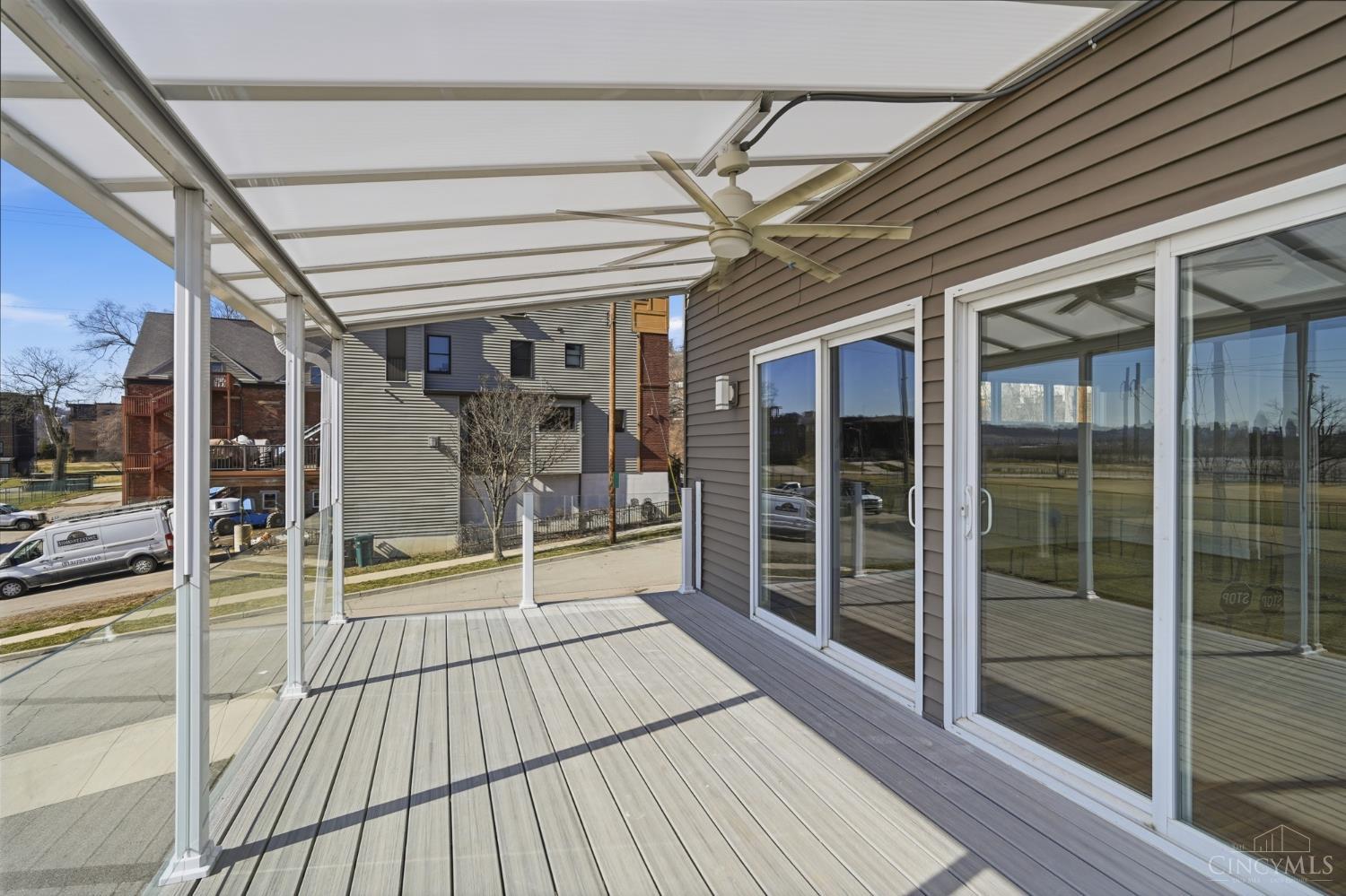 3003 Riverside Drive Cincinnati, OH 45226 - Photo 16 of 65 First floor covered balcony is designed with Resin composite decking, a ceiling fan, glass railing system, and opaque roofing.