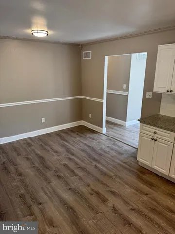 a view of a livingroom with wooden floor