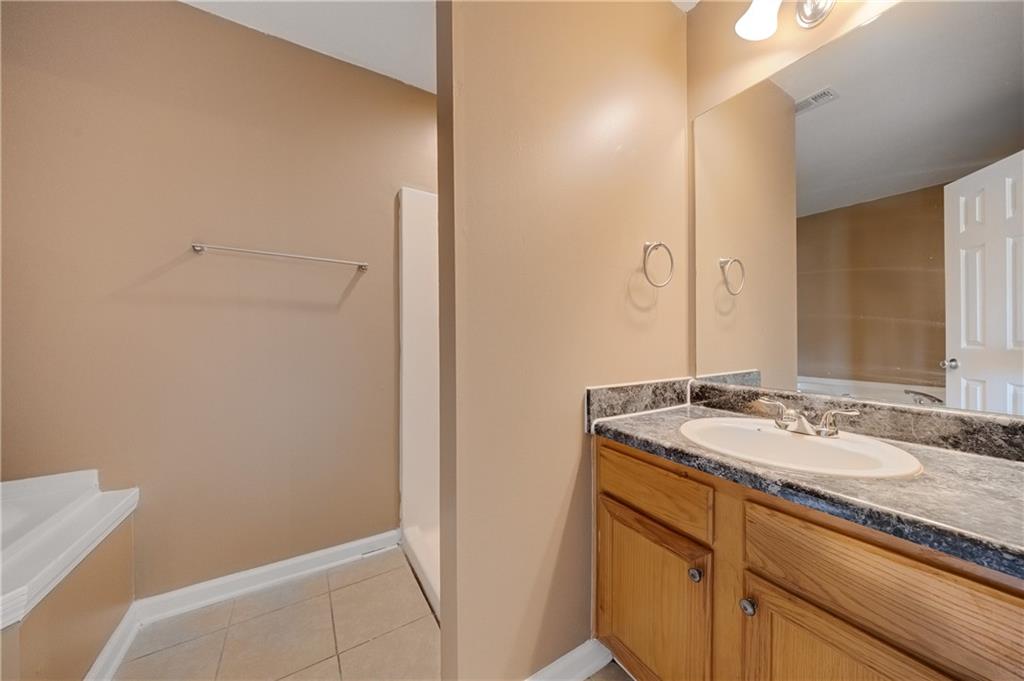 4203 Legacy Square Atlanta, GA 30349 - Photo 28 of 35 a bathroom with a granite countertop sink and a mirror