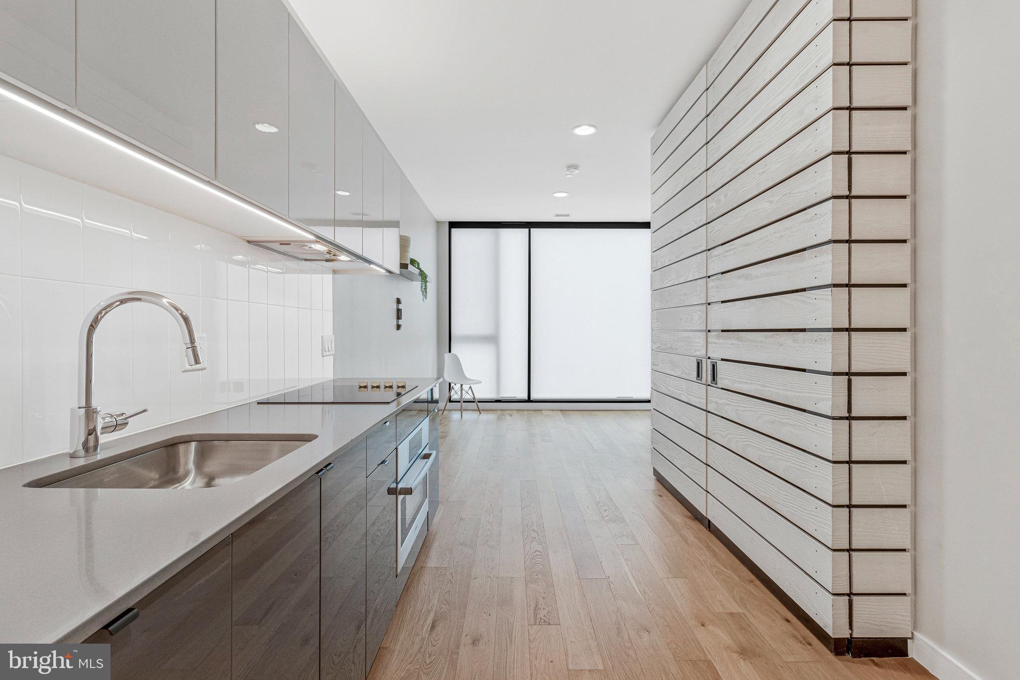 57 N Street Northwest, Unit 433 Washington, DC 20001 - Photo 5 of 58 Laundry + utilities hidden behind the custom doors