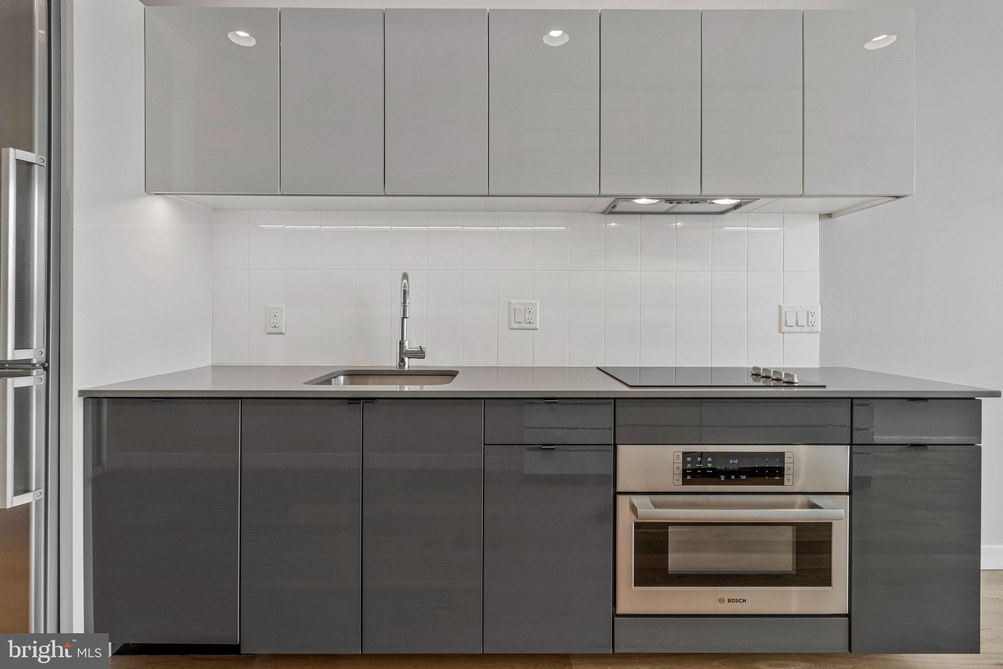 57 N Street Northwest, Unit 433 Washington, DC 20001 - Photo 7 of 58 Sleek two tone cabinetry.