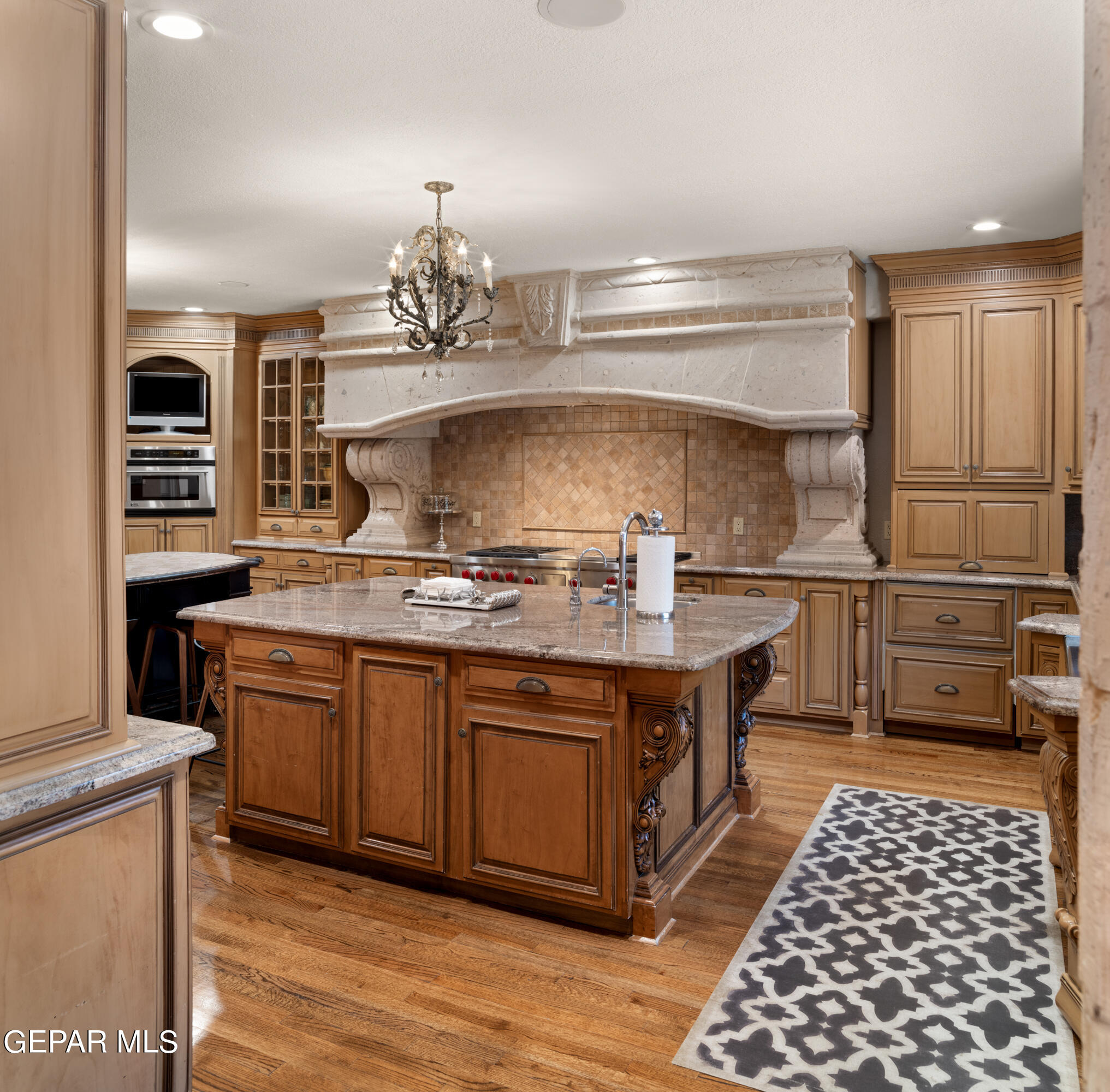813 Rosinante Road El Paso, TX 79922 - Photo 29 of 67 a kitchen with stainless steel appliances granite countertop a stove and a refrigerator