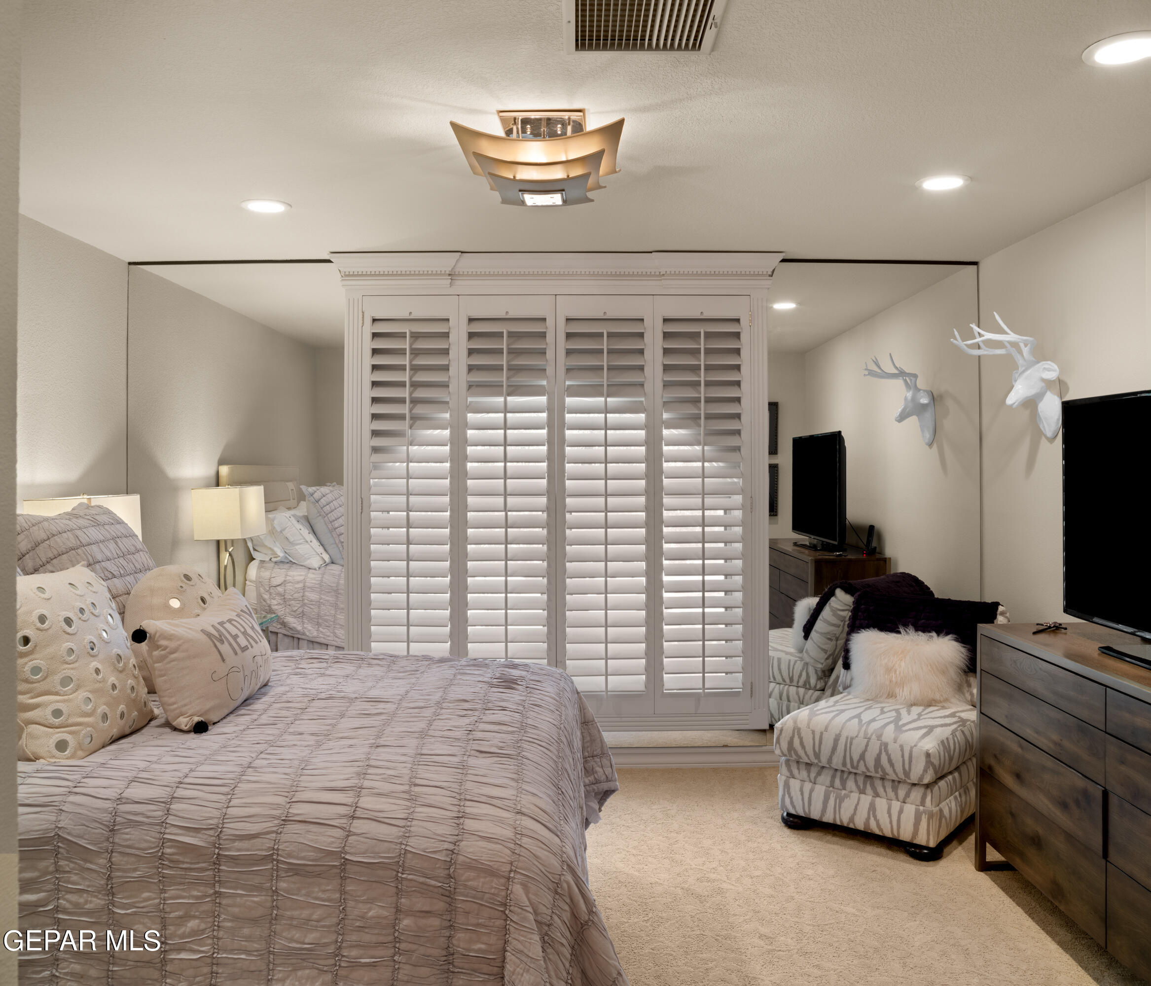813 Rosinante Road El Paso, TX 79922 - Photo 58 of 67 a bedroom with a large bed and a flat screen tv