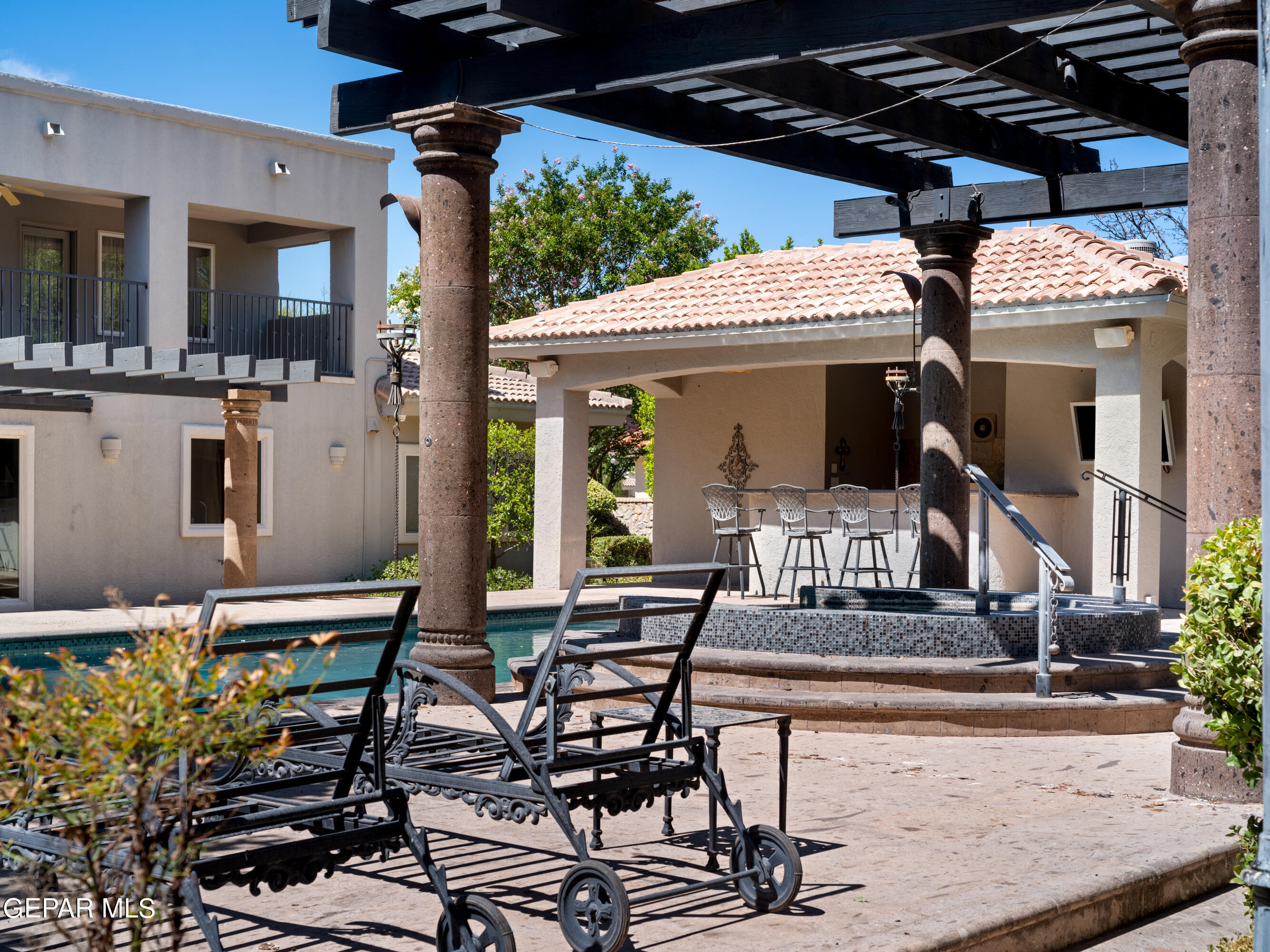 813 Rosinante Road El Paso, TX 79922 - Photo 66 of 67 a view of a patio with table and chairs potted plants and floor to ceiling window