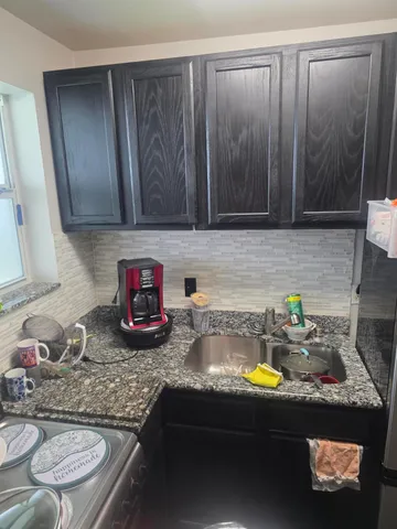 a kitchen with a sink and a stove