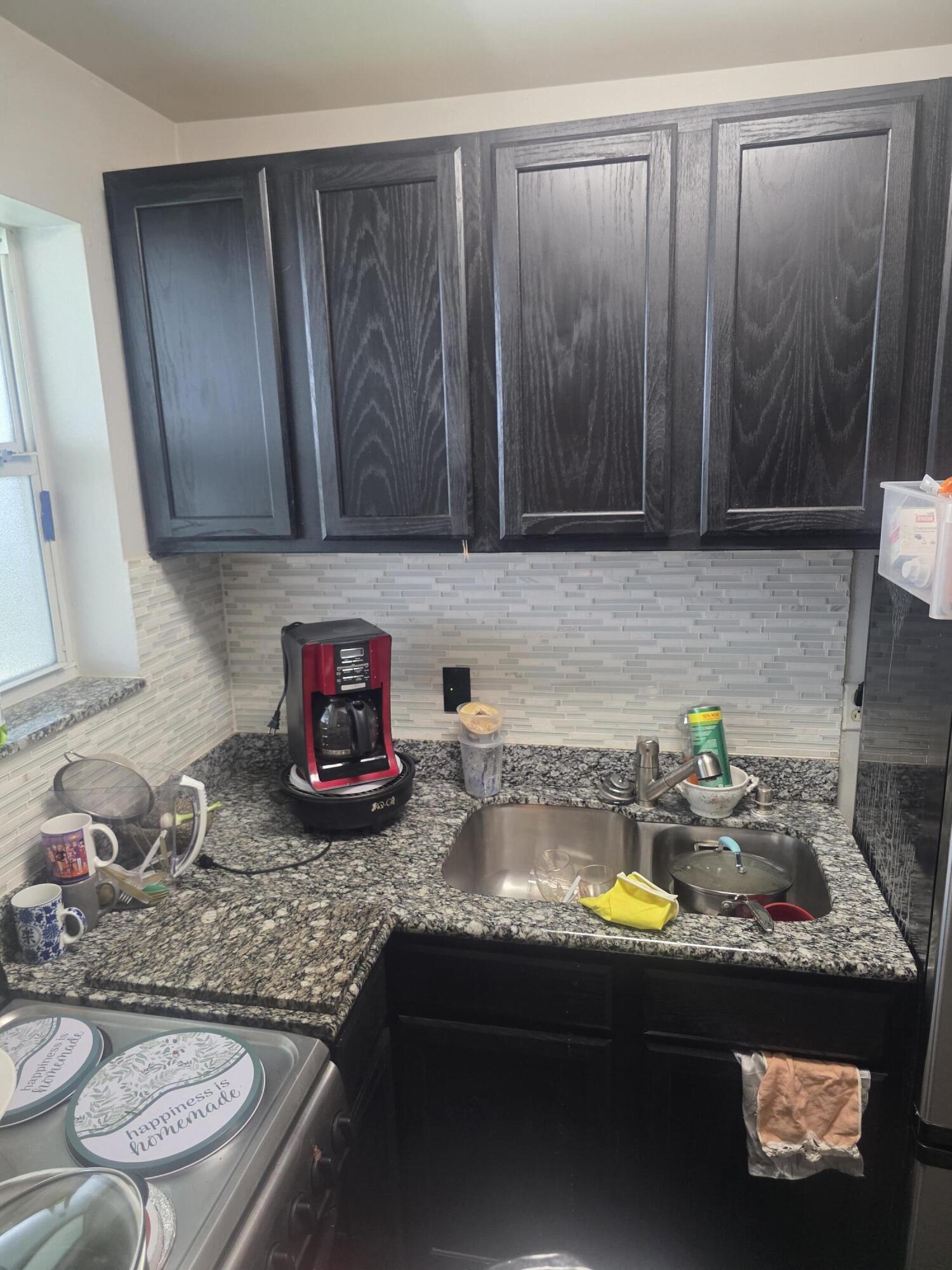 302 Lake Osborne Drive, Unit 4 Lake Worth Beach, FL 33461 - Photo 5 of 10 a kitchen with a sink and a stove