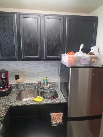 a kitchen with a sink a stove and a cabinets
