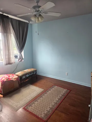 a bedroom with a bed closet and a window