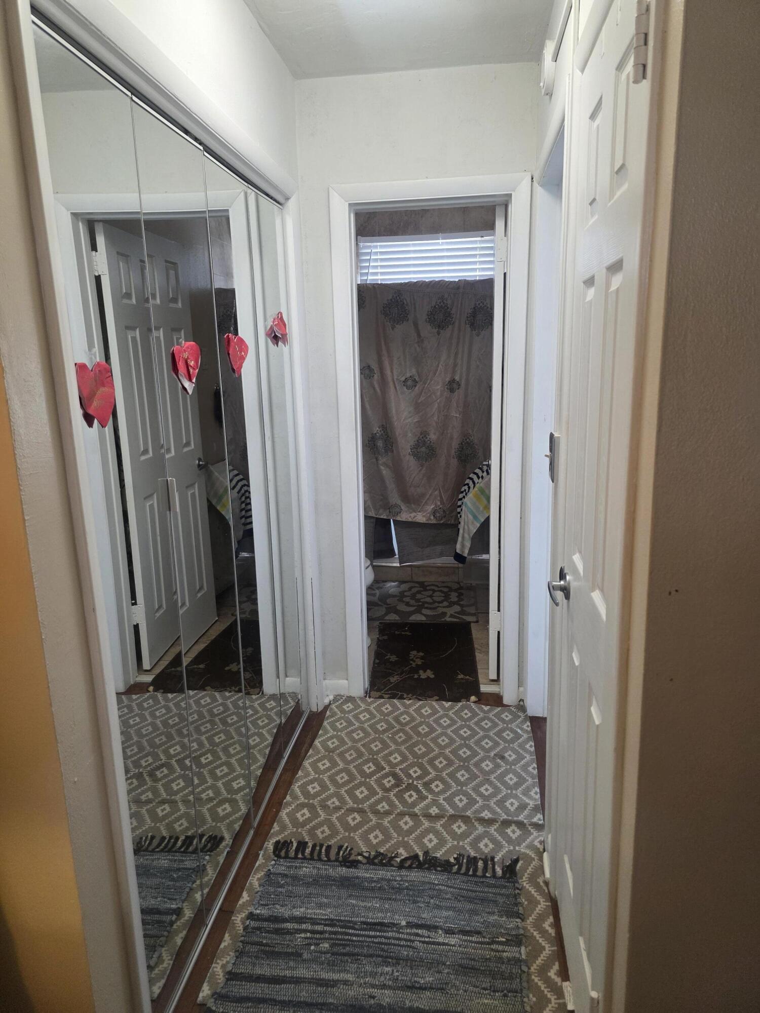 302 Lake Osborne Drive, Unit 4 Lake Worth Beach, FL 33461 - Photo 9 of 10 a bedroom with a bed and a walk in closet