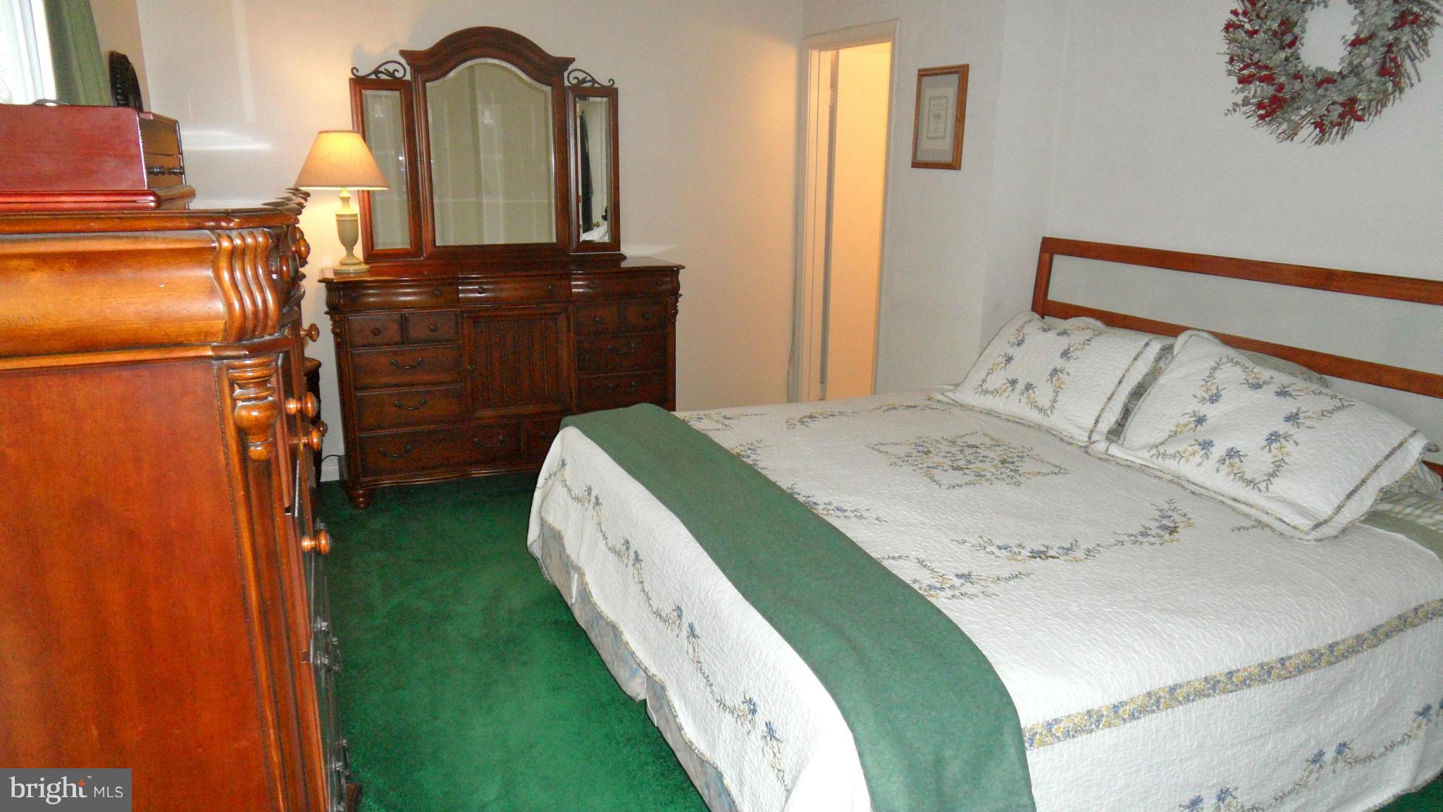 1209 Hilltop Road Curtis Bay, MD 21226 - Photo 11 of 24 a bedroom with a bed and dresser with mirror