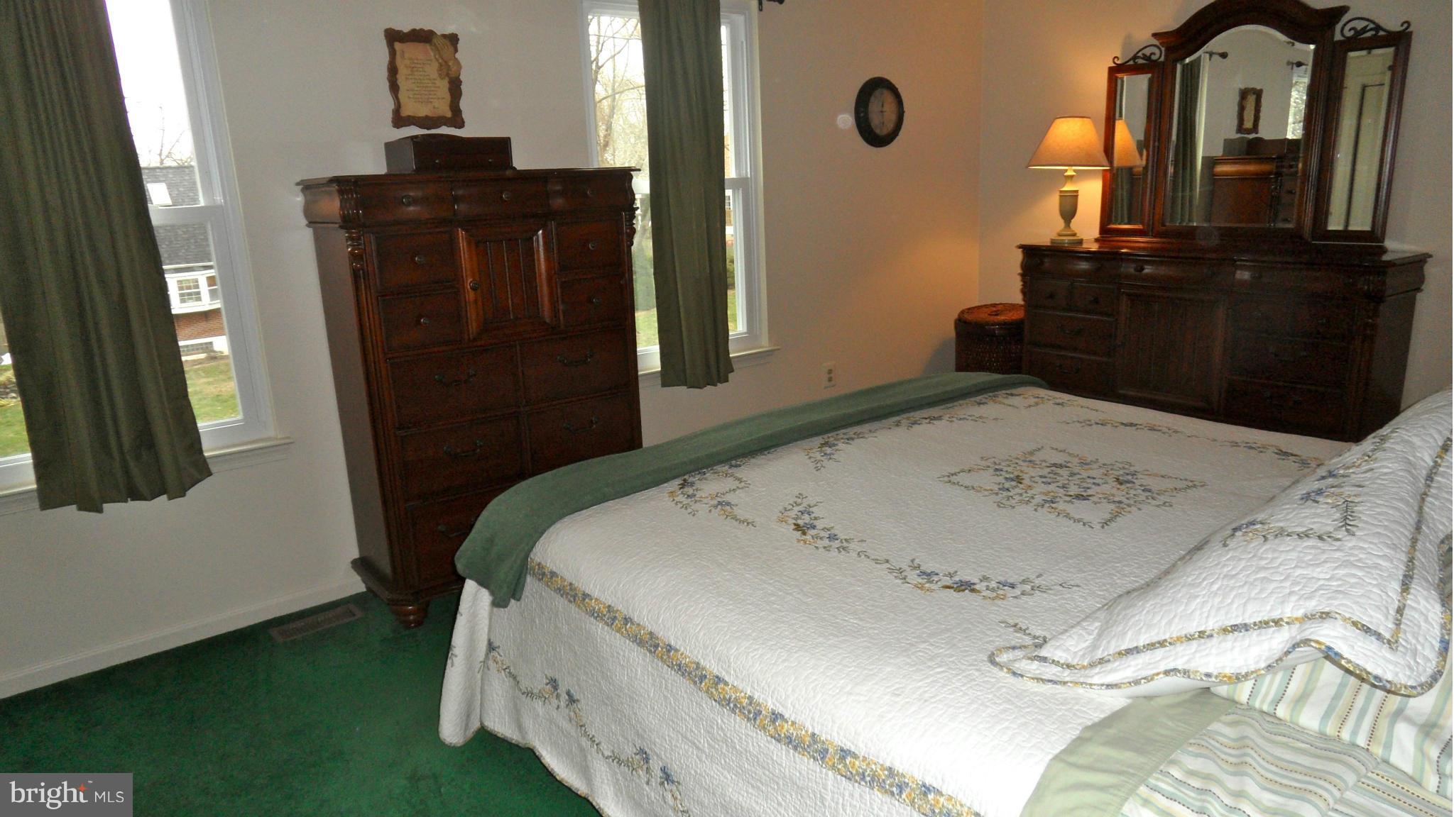 1209 Hilltop Road Curtis Bay, MD 21226 - Photo 12 of 24 a bed sitting in a bedroom next to a window with dresser