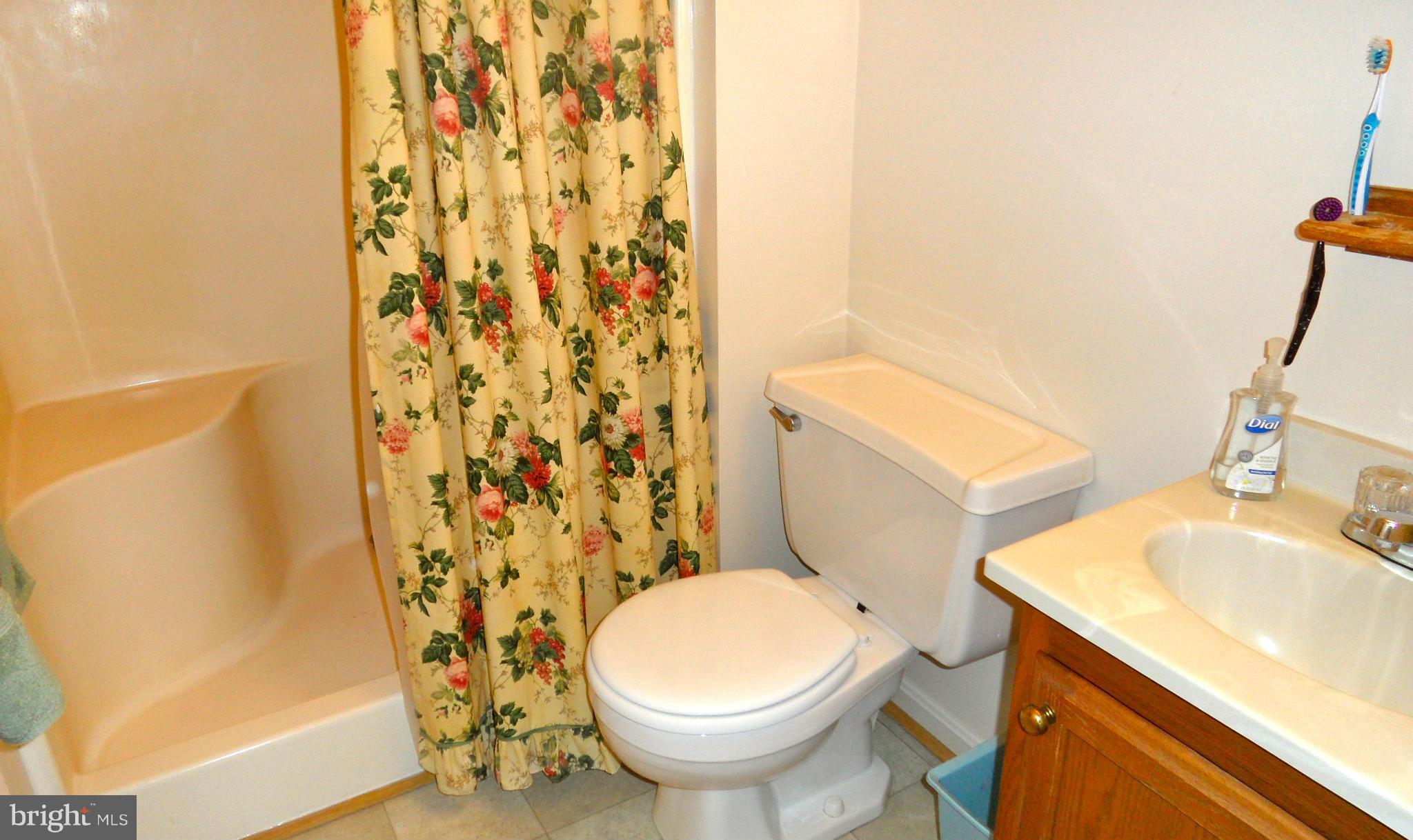 1209 Hilltop Road Curtis Bay, MD 21226 - Photo 13 of 24 a white toilet sitting next to a bathroom sink