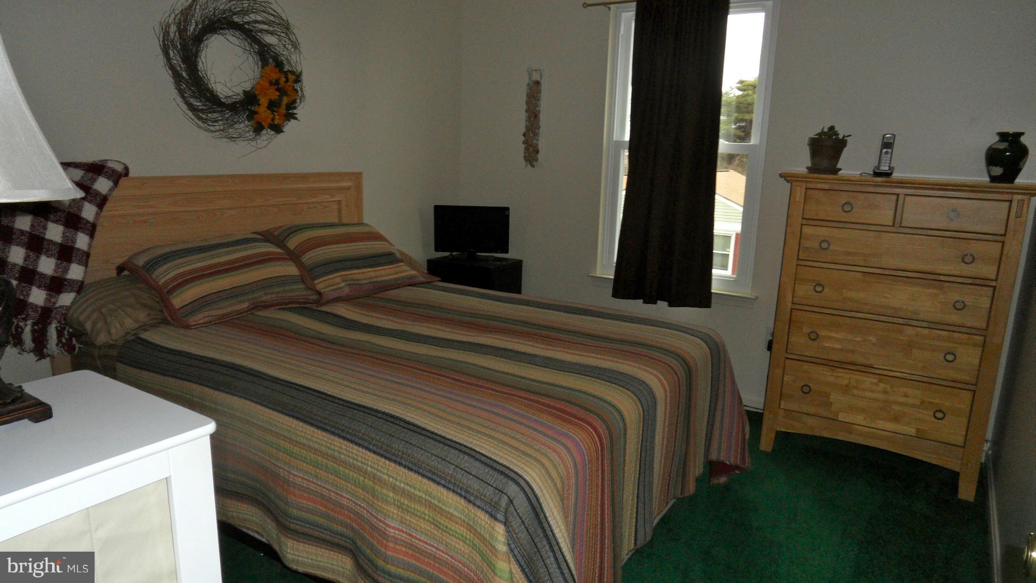 1209 Hilltop Road Curtis Bay, MD 21226 - Photo 15 of 24 a bedroom with a bed and a dresser