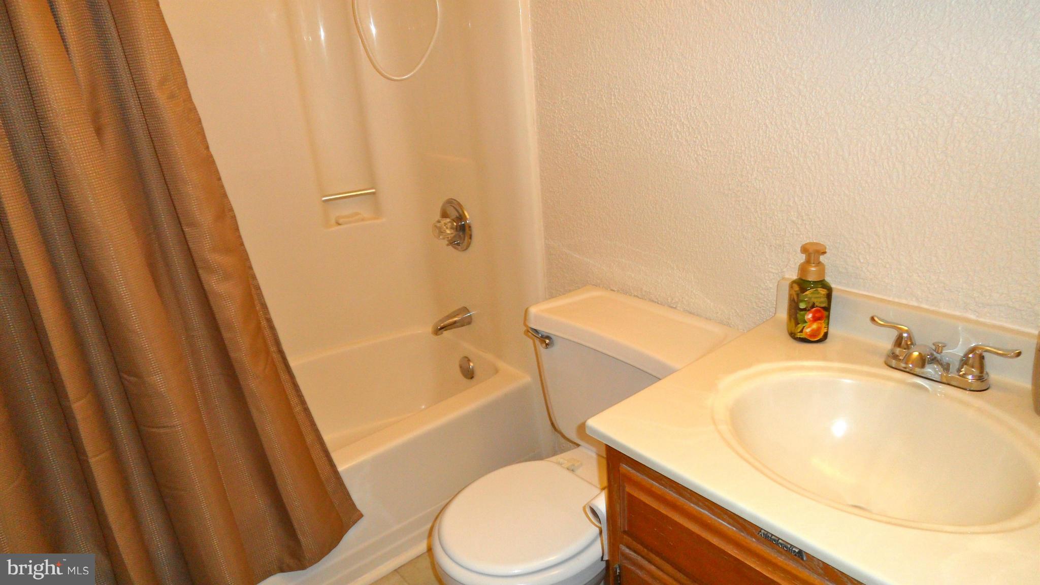 1209 Hilltop Road Curtis Bay, MD 21226 - Photo 17 of 24 a bathroom with a sink a toilet and tub