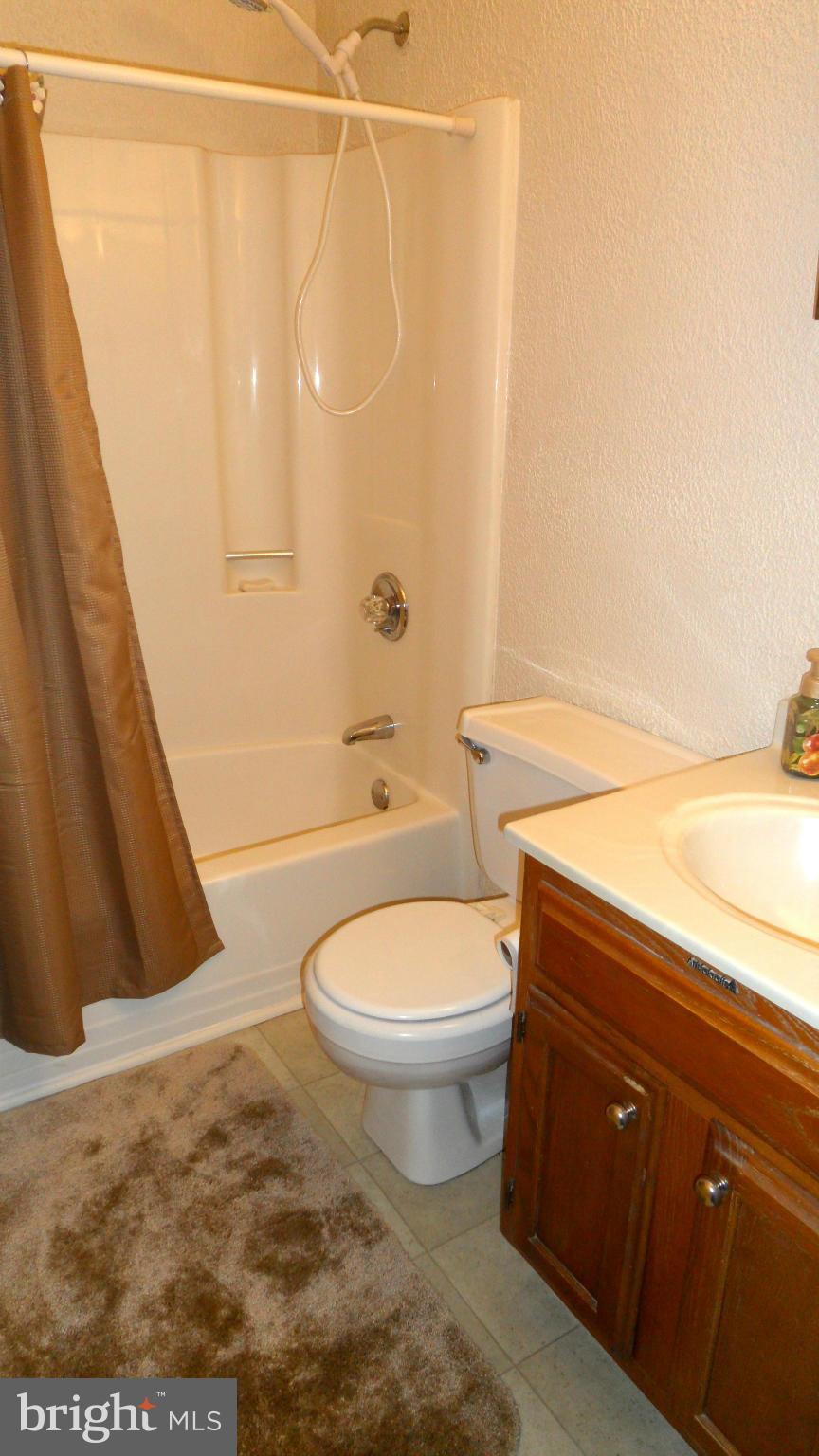 1209 Hilltop Road Curtis Bay, MD 21226 - Photo 18 of 24 a bathroom with a toilet a sink and bathtub