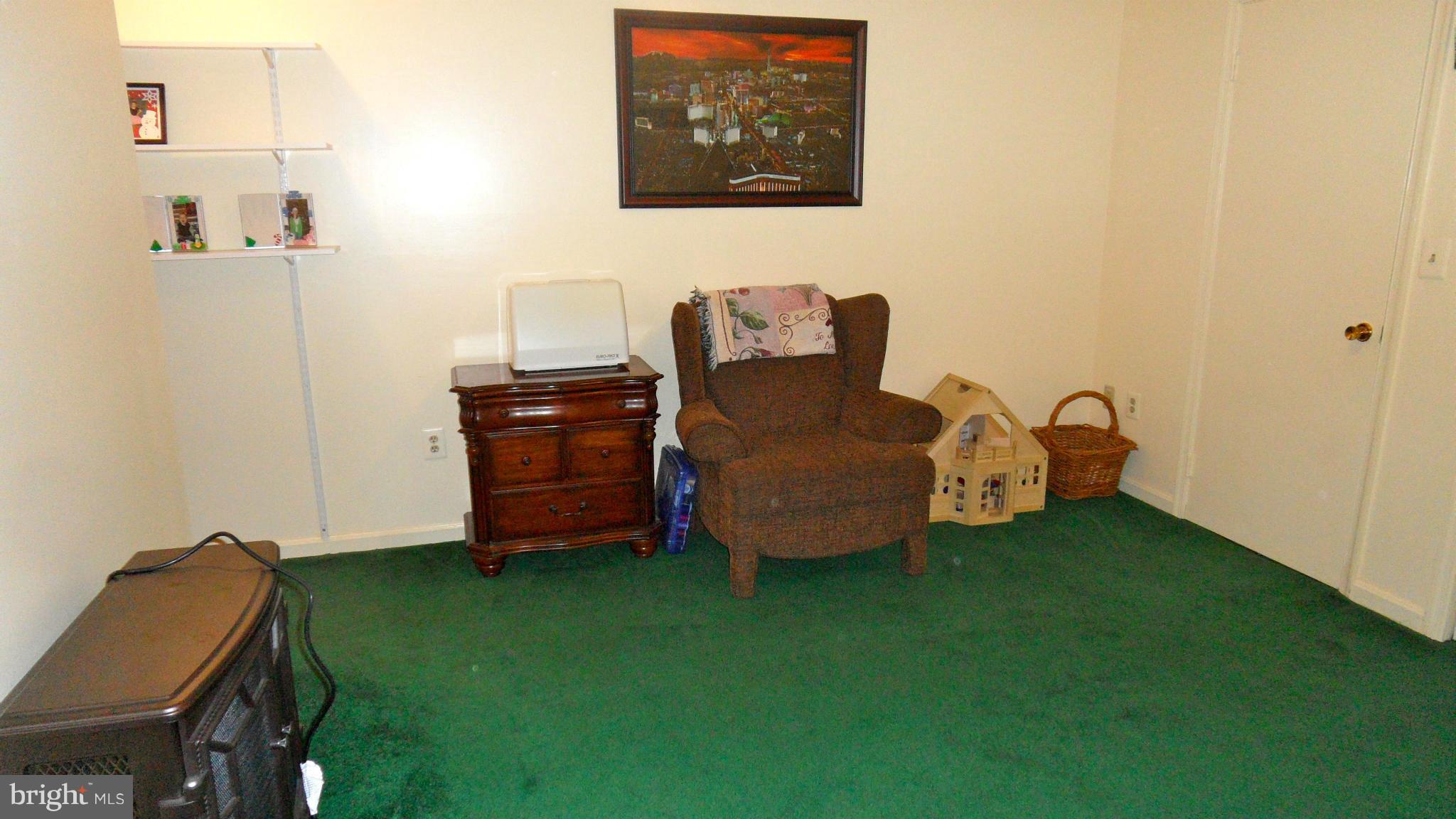 1209 Hilltop Road Curtis Bay, MD 21226 - Photo 20 of 24 a room with a chair and a wooden floor