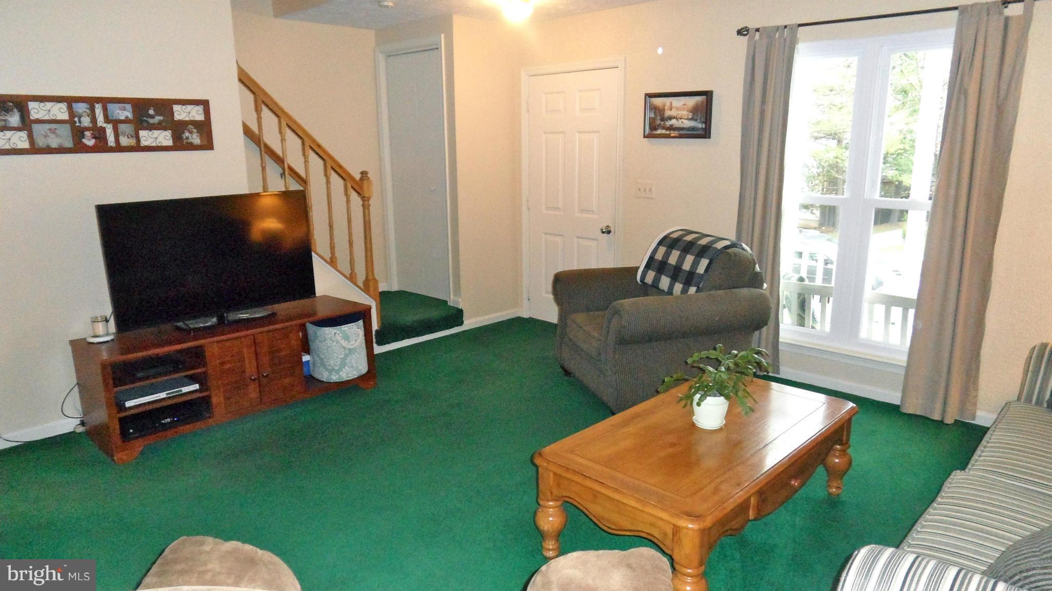 1209 Hilltop Road Curtis Bay, MD 21226 - Photo 5 of 24 a living room with furniture and a flat screen tv