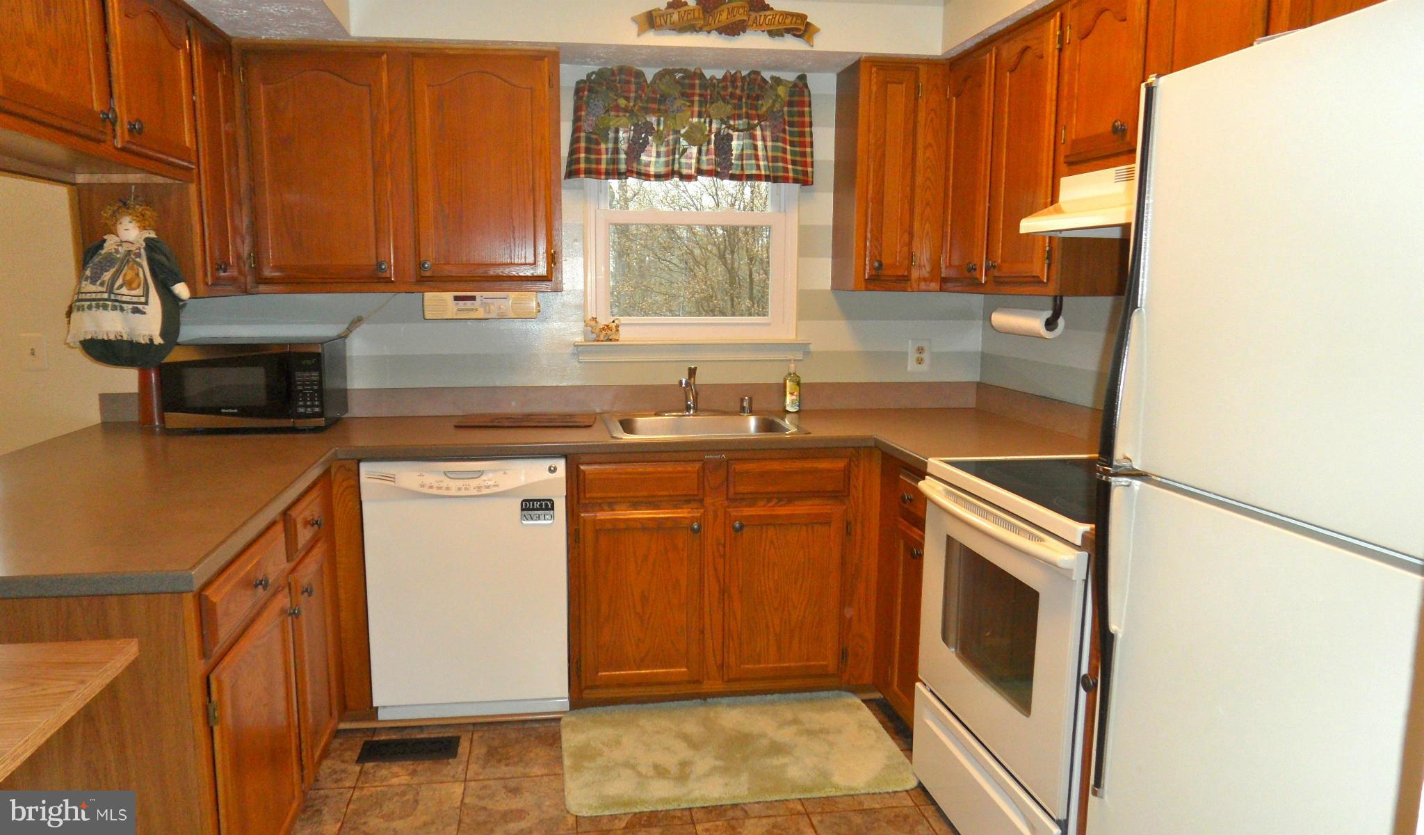1209 Hilltop Road Curtis Bay, MD 21226 - Photo 6 of 24 a kitchen with a sink stove and cabinets