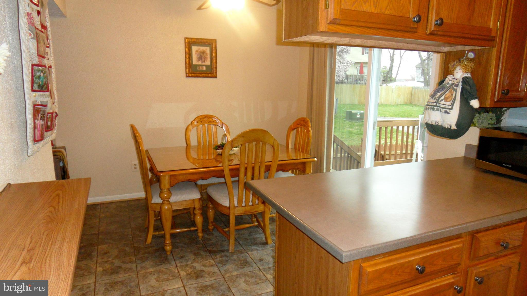 1209 Hilltop Road Curtis Bay, MD 21226 - Photo 7 of 24 a view of a dining room with furniture and a window