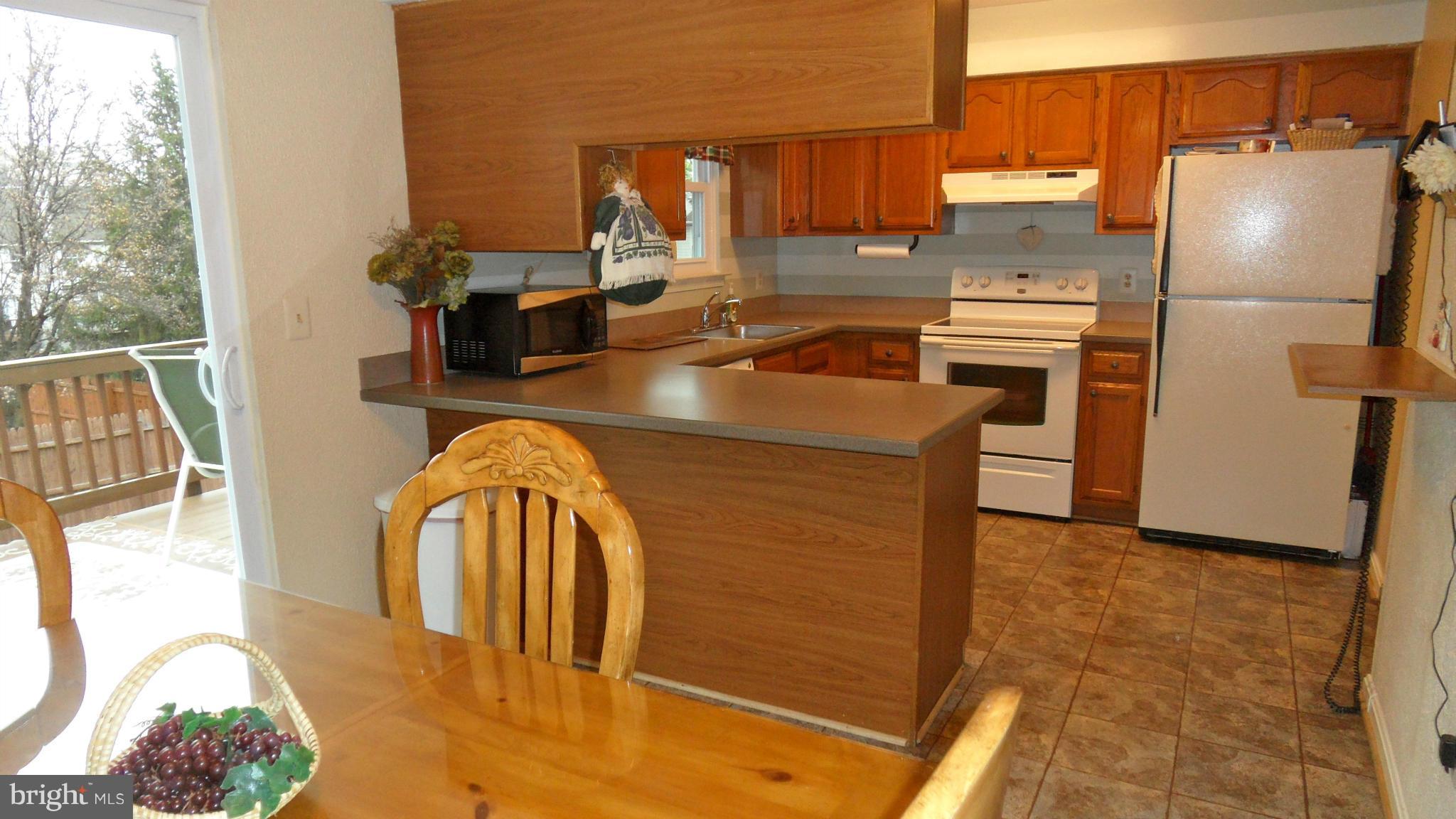1209 Hilltop Road Curtis Bay, MD 21226 - Photo 9 of 24 a kitchen with stainless steel appliances granite countertop a refrigerator a stove and a sink with couches